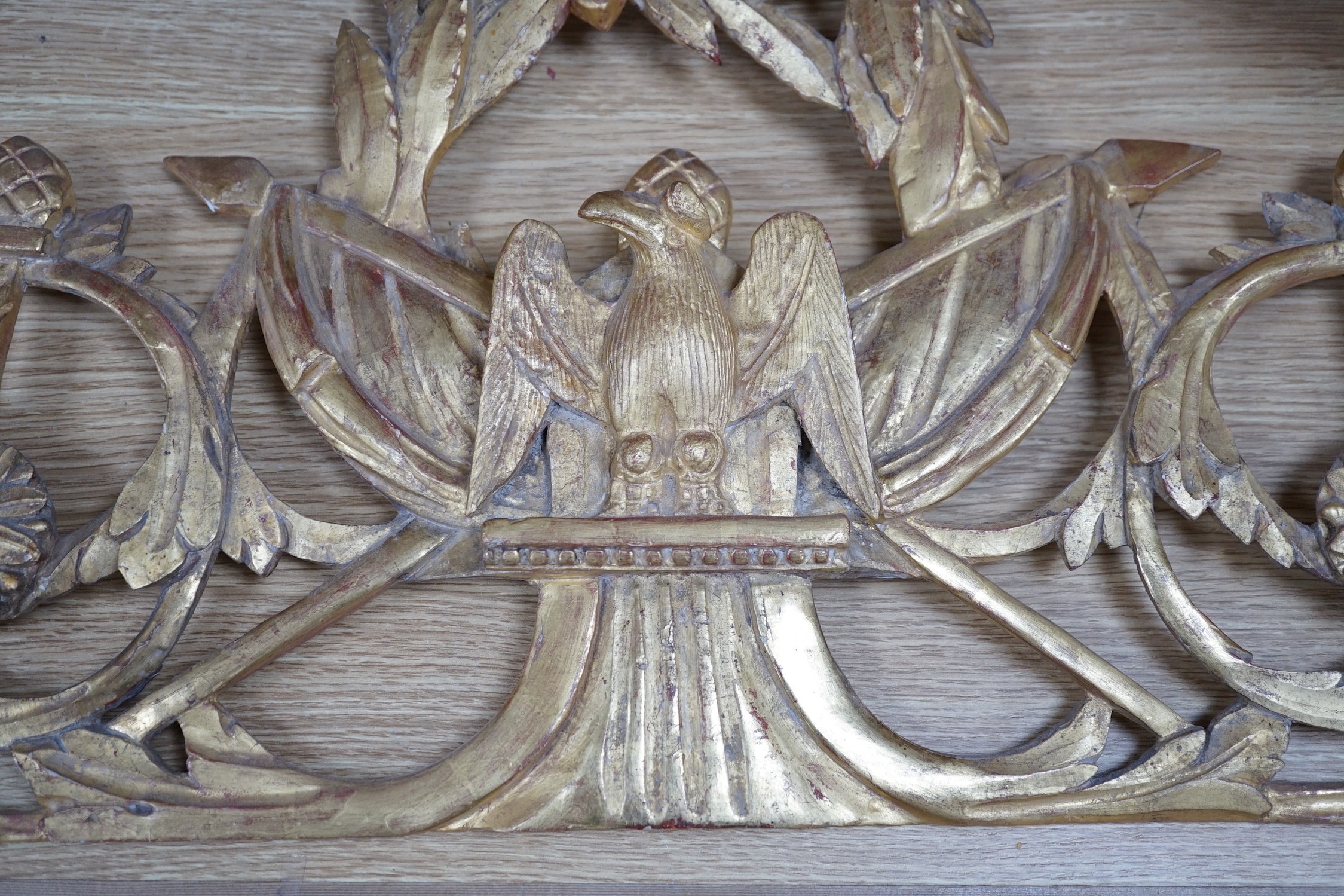 A 19th century ornate carved giltwood eagle surmount, 39cms high x 92cms wide